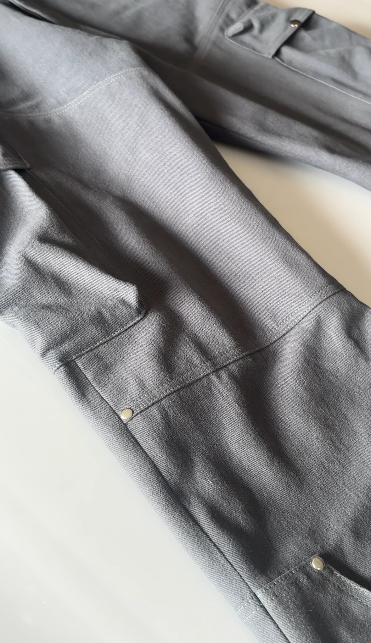 Gray pants with buttons on a light background